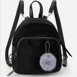black mini bookbag with fur keychain